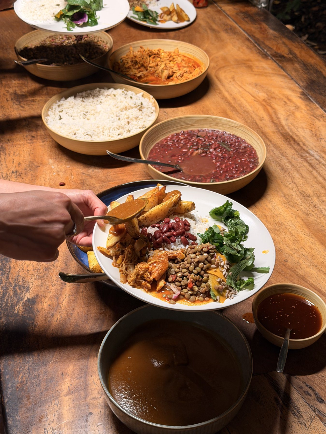 A table of chef-made dishes at Tierramor: rice, beans, mole and roasted plantain