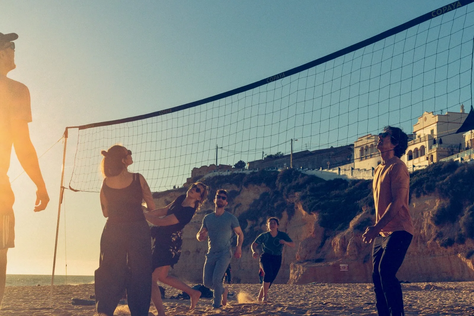 Innate residents playing beach volleyball at sunset