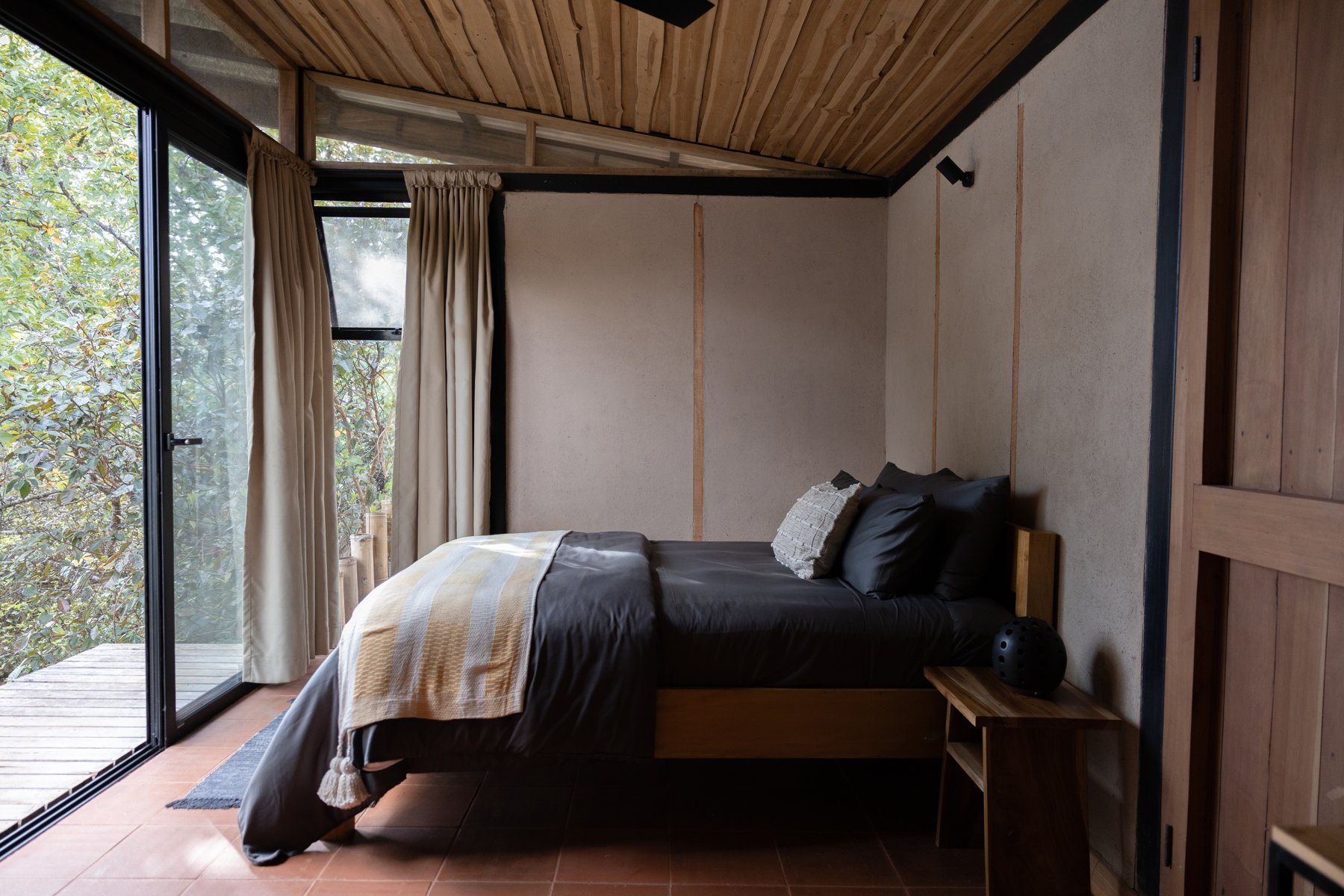 A quiet casita bedroom opening directly onto the jungle