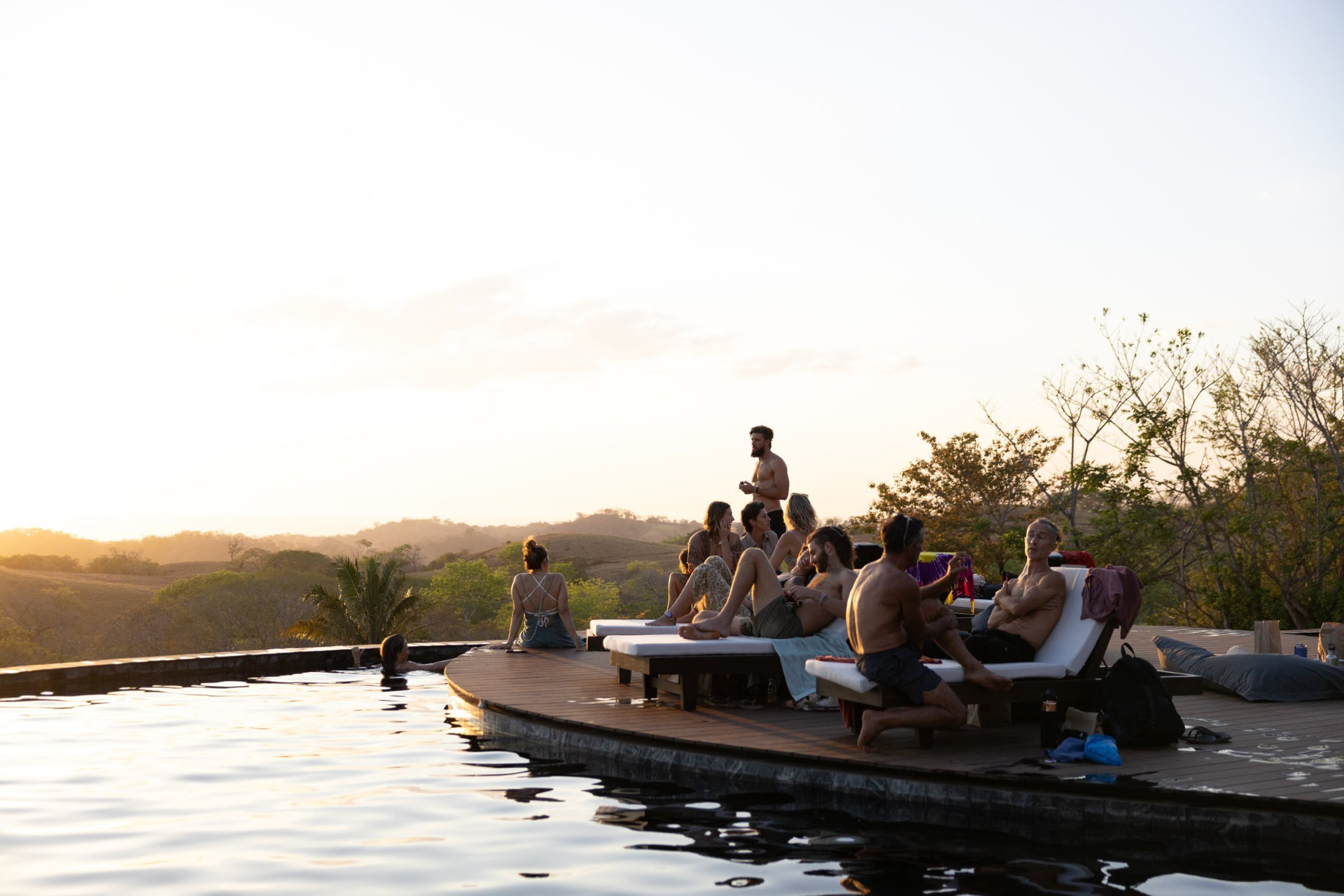 Innate residents relaxing beside Tierramor's saltwater pool at sunset