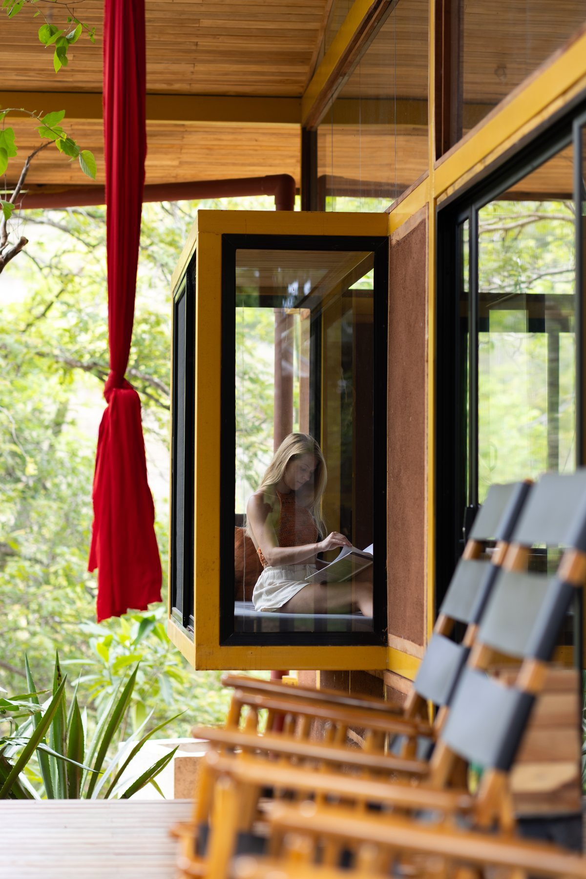 A resident reading in Tierramor's glass-walled coworking space