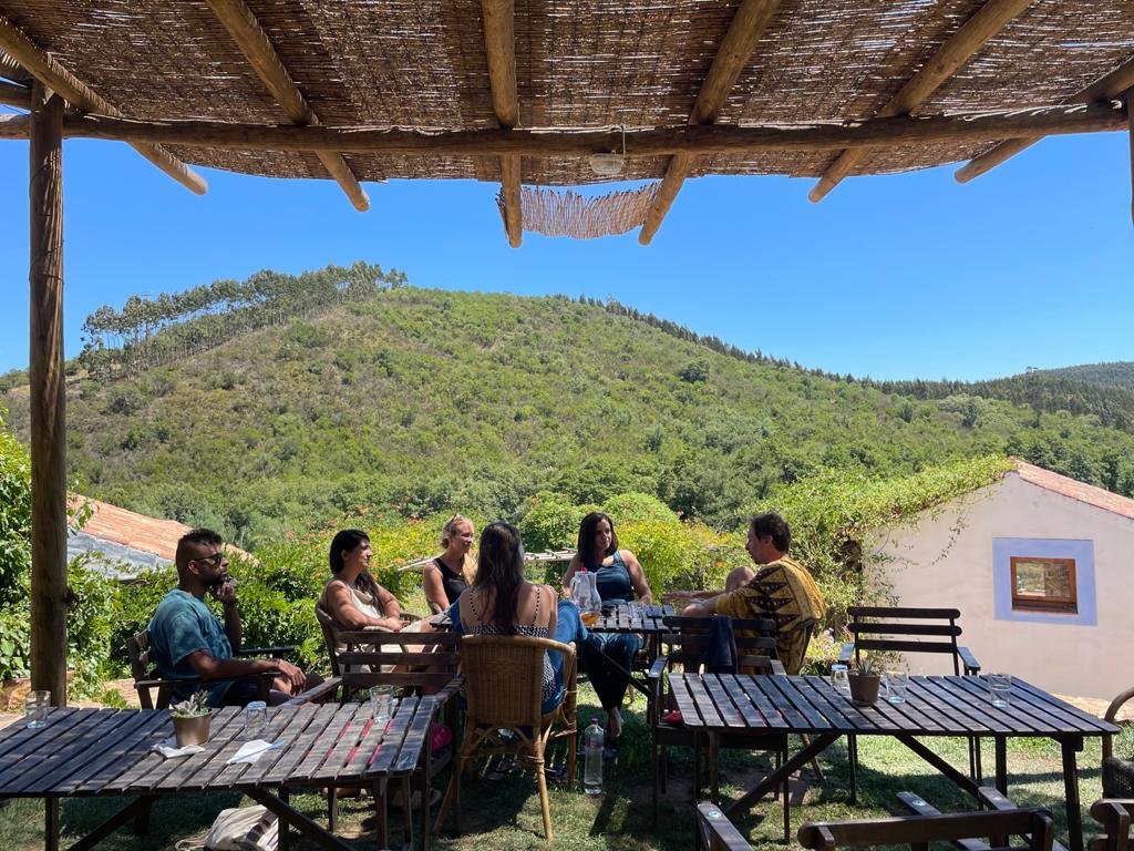 Residents sharing a table on a terrace overlooking nature