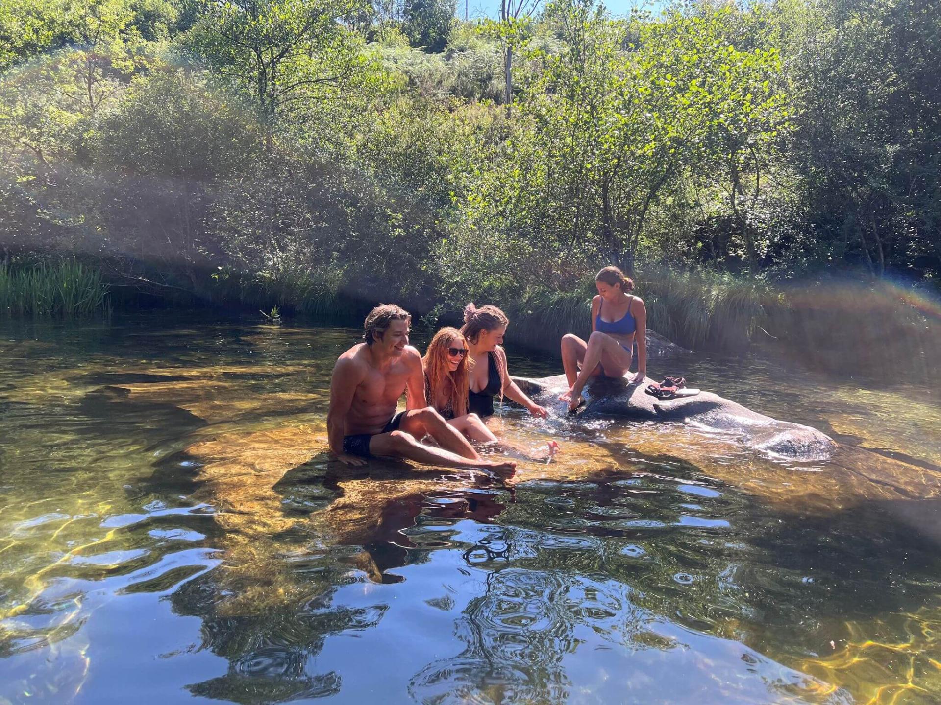 Friends relaxing together in a sunlit river